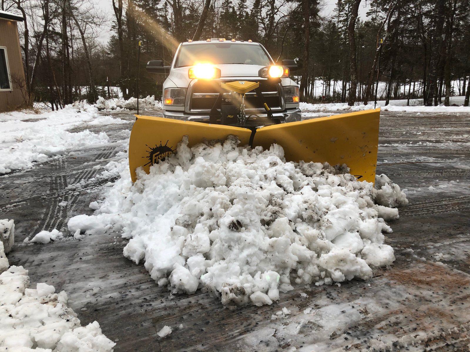TLC snow plow clearing accumulated snow